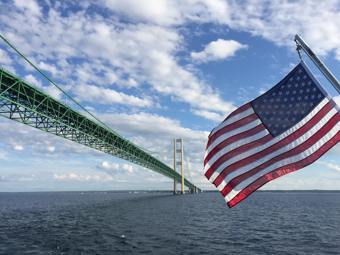 The Mackinac Bridge and an American flag from the water